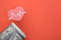 Heart beat and money banknotes. symbolizing the concept of tracking health expenses or medical costs Royalty Free Stock Photo