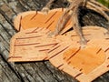 The heart of birch bark on a wooden background. Manual work in design Royalty Free Stock Photo