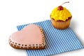 Heart biscuit and yellow cupcake. Royalty Free Stock Photo