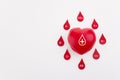 Heart and blood drops with different blood types on white background. Top view