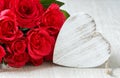 Heart and a bouquet of red roses on wooden board, Valentines Day background Royalty Free Stock Photo