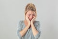 Heart broken young blond woman crying expressing feelings under shock Royalty Free Stock Photo