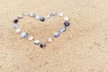 Heart built of sea shells on the sand Royalty Free Stock Photo