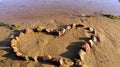 Heart, built of stones, on the sandy Bank of the river Royalty Free Stock Photo