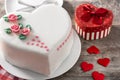 Heart cake for St. Valentine`s Day, Mother`s Day, or Birthday, decorated with roses and pink sugar hearts on wooden table Royalty Free Stock Photo