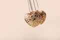 Heart on chain. Three golden hearts. Valentine`s Day holiday. Golden hearts for boys and girls