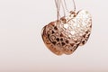 Heart on chain. Three golden hearts. Valentine`s Day holiday. Golden hearts for boys and girls