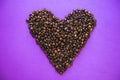 Heart coffee of coffee beans on burlap texture.