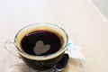 Heart of coffee in a glass cup