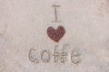 Heart of coffee. Grains of coffee are laid out on sand in the form of heart. Love of coffee. The inscription I love coffee