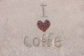 Heart of coffee. Grains of coffee are laid out on sand in the form of heart. Love of coffee. The inscription I love coffee