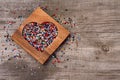 Heart from colourful beads in wooden heart-shaped box