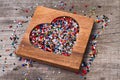 Heart from colourful beads in wooden heart-shaped box