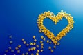 Heart consists of yellow puzzle figures on blue background with copy space