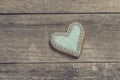 Heart cookie covered with blue icing and edible pearl beads