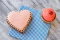 Heart cookie and pink cupcake.