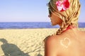 Heart of the cream on the female back on the beach Royalty Free Stock Photo