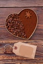 Heart created of coffee beans and instant coffee on wooden background. Royalty Free Stock Photo