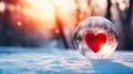 Heart in crystal ball on snowy forest