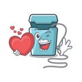 With heart dental floss in a mascot box Royalty Free Stock Photo