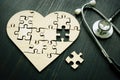 Heart disease like heart attack concept. Puzzle and stethoscope Royalty Free Stock Photo