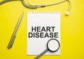 Heart disease with notepad with stethoscope on desk Royalty Free Stock Photo