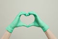 Heart of doctor gloves hands. The heart from the hands in medical gloves on white background