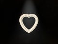 Heart with a door handle on a black background. The white heart opens with a hand. Concept: closed heart Royalty Free Stock Photo