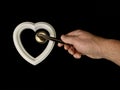 Heart with a door handle on a black background. The white heart opens with a hand. Concept: closed heart Royalty Free Stock Photo