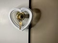 Heart on a doorknob with a key. The white heart opens with keys. Concept: closed heart Royalty Free Stock Photo