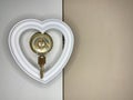 Heart on a doorknob with a key. The white heart opens with keys. Concept: closed heart Royalty Free Stock Photo