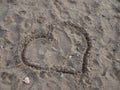 Heart drawn on beach sand in autumn Royalty Free Stock Photo