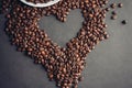heart drawn from coffee beans and a cup with a drink saucer breakfast in bed Royalty Free Stock Photo