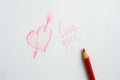 Heart drawn on paper, the inscription love you and a red pencil on white paper Royalty Free Stock Photo