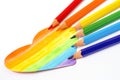 A heart is drawn with pencils in the colors of the LGBT flag