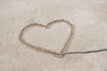 the heart is drawn on the sand on the beach with a stick Royalty Free Stock Photo