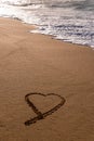 Heart drawn in the sand on the beach at sunset Royalty Free Stock Photo