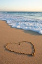 Heart drawn in the sand on the beach at sunset. Heart shape. Heart symbol. Love. Sea ??foam. Royalty Free Stock Photo