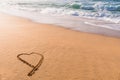 Heart drawn in the sand on the beach at sunset Royalty Free Stock Photo