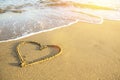 Heart drawn on the sand of a sea beach. Royalty Free Stock Photo