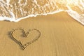 Heart drawn in sea beach sand, soft wave in a Sunny summer day. Love. Royalty Free Stock Photo