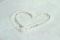 A heart drawn in the snow, winter white background Royalty Free Stock Photo