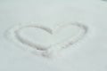 A heart drawn in the snow, winter white background Royalty Free Stock Photo