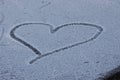 heart is drawn in snowy glade. background for decoration for holiday of Valentine& x27;s Day. Cold heart, love. white Royalty Free Stock Photo