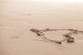 Heart drawn in the sand. Beach background. Top view Royalty Free Stock Photo