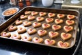 heart emoji-shaped cookies on a baking tray