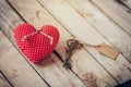 Heart fabric and vintage key with tag on wood table background Royalty Free Stock Photo