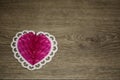 Heart figure from paper. pink heart. white contour. brown background