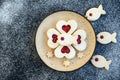 Heart and fish shaped linzer cookies filled with strawberry jam Royalty Free Stock Photo