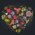 Heart floral design on dark background with ylang-ylang, impatiens, daffodil, tigridia, lotus, aquilegia